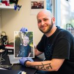 Ryan Kohn, a PhD candidate in the MIT Biology Department’s Jacks Lab, holds a photo of his son, Jayden.