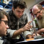 Professor Alex Slocum (right) works with students Alban Cobi and Steven Link, who are developing an adjustable phantom for radiotherapy validation. Credit: John Freidah.