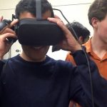 Student trying on virtual reality goggles