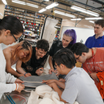 Students examining fabric