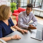 Amy Glasmeier (left) and MIT sophomore Taimor Williams discuss his research project