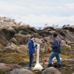 students on rocky shoreline