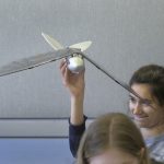 A student examines a "bird plane"