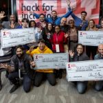 The three winning teams from the Hack for Inclusion 2020 and the crowd's favorite pose with their checks.