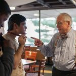 Bill Hecht '61 SM'76 shows students how to tie a bowtie at Charm School