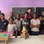 Students pose with their toy, "FIFAction,” which was built during a toy design class with MIT student Eli Brooks. Brooks drew inspiration from MIT’s mechanical engineering class 2.00b (Toy Product Design) when teaching his class.