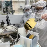 first-year undergraduate Audrey Lee loads an electron-beam evaporator with silicon wafers, a process step in the creation of a solar cell..