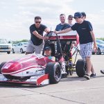 Caption:Cheyenne Hua ’19 (seated) served as captain of MIT Motorsports during her time as an undergraduate. She now works at SpaceX as a structures engineer.